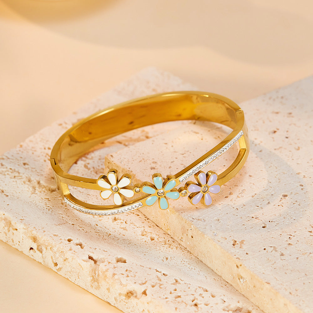 Little Daisy Gold Bracelet  over a table