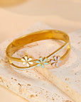 Little Daisy Gold Bracelet  over a table