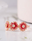 Three pink daisy rings