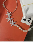 Sterling Silver Starfish Charm Anklet over a table