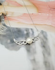 Angel Feather Inlaid Pearl Necklace for Women over a girl's photo