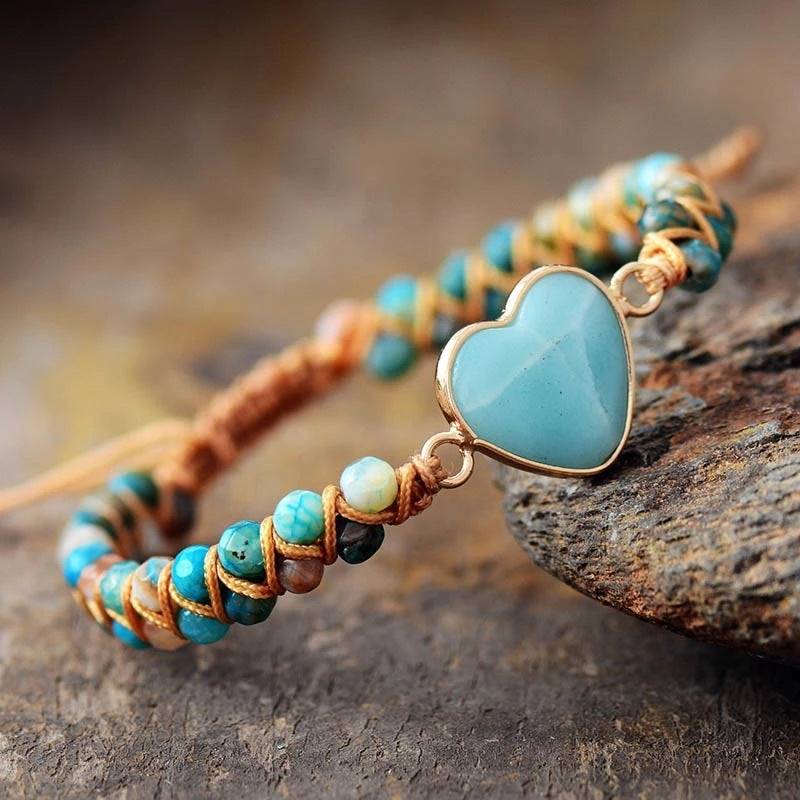 Amazonite String Braided Heart Bracelet beside a stone