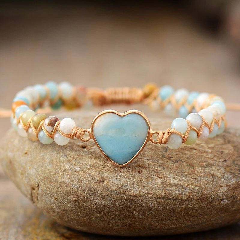 Amazonite String Braided Heart Bracelet with white beads over a stone