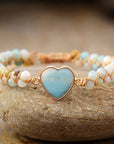 Amazonite String Braided Heart Bracelet with white beads over a stone