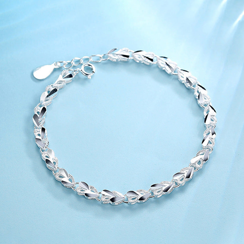 Sterling Silver XO Bracelet in blue background