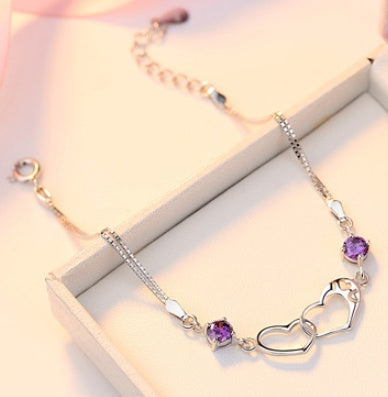 Amethyst Love Links Bracelet on a table