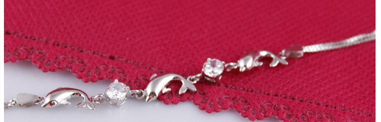 925 Sterling Silver Dolphin Bracelet over a red cloth