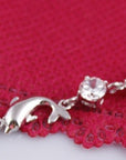 925 Sterling Silver Dolphin Bracelet over a red cloth