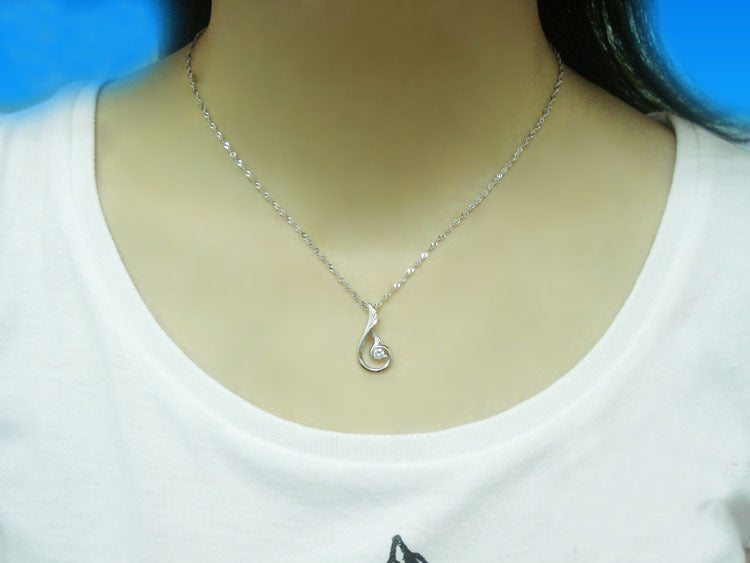 White dressed woman wearing Zircon Fire Phoenix Necklace