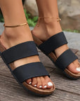 Girl wearing Black colored Beach Open Toe Flat Sandals over wood