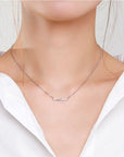 White dressed girl wearing S925 Sterling Silver Wave Pendant Necklace