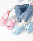 Girl wearing blue colored and holding pink colored Soft Cloud Design Cute House Slippers for Women