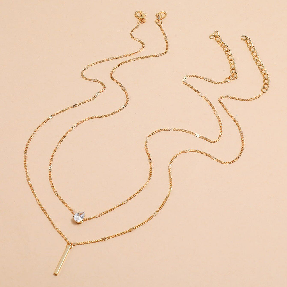 Gold colored chain and necklace with silver diamond