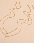 Gold colored chain and necklace with silver diamond