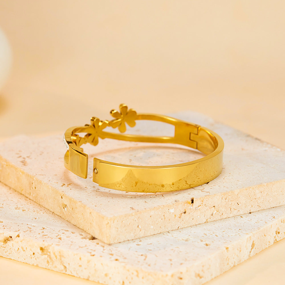 Little Daisy Gold Bracelet over a square brick