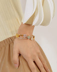 Little Daisy Gold Bracelet close photoshoot of woman's hand