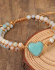 Amazonite String Braided Heart Bracelet over a wood