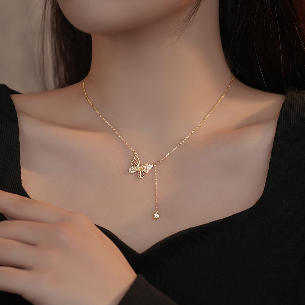 Girl wearing gold colored hollow butterfly necklace