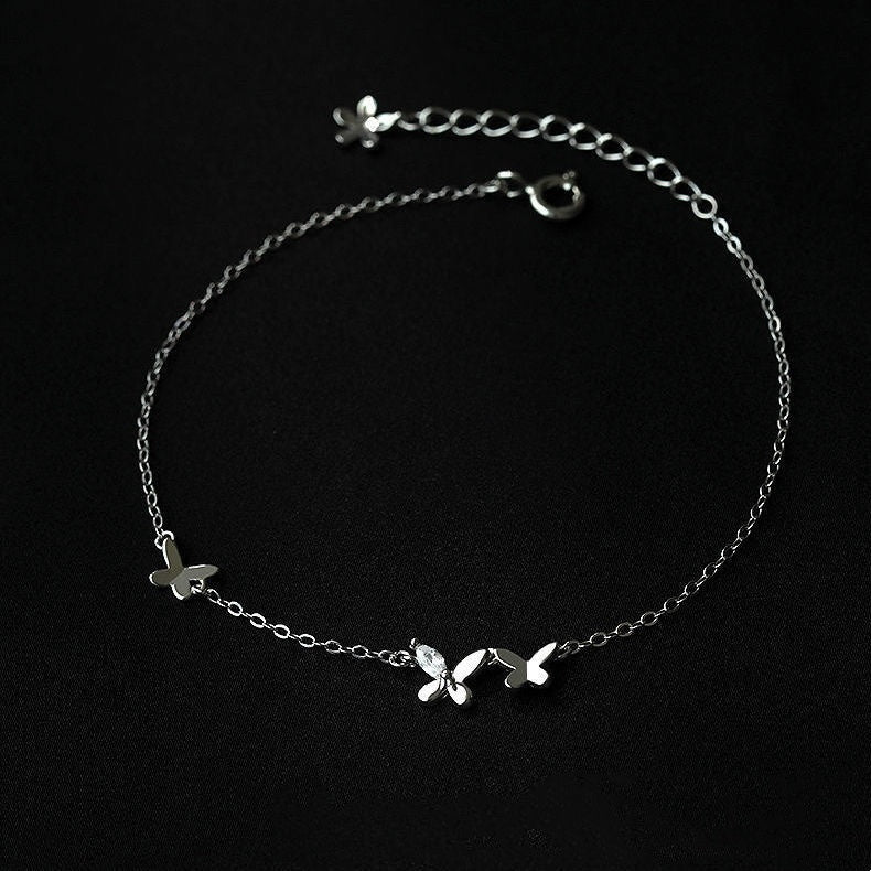 S925 Sterling Silver Butterfly Anklets for Women in black background photoshoot