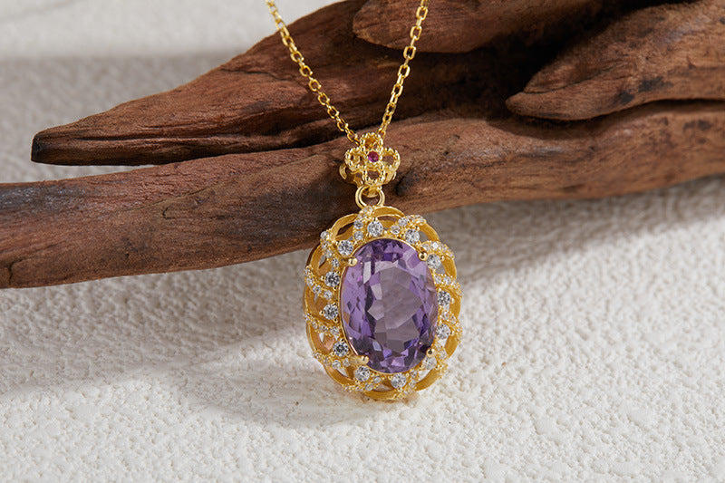 Sterling Silver Inlaid Amethyst Drop Necklace in front of wood