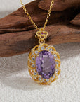 Sterling Silver Inlaid Amethyst Drop Necklace in front of wood