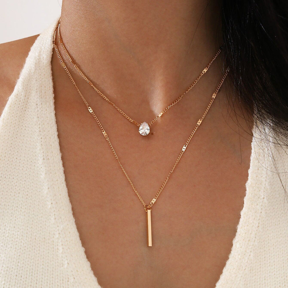 Girl wearing gold colored Small Diamond Long Fringe Pendant Necklace