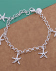 925 Silver Starfish Pendant Bracelet over green and wood table