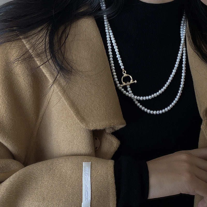 Black top woman wearing Natural Freshwater Long Pearl Necklace