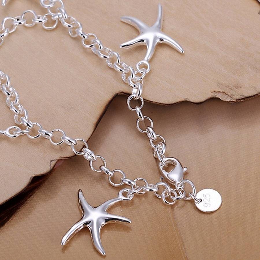 925 Silver Starfish Pendant Bracelet over boards