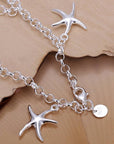 925 Silver Starfish Pendant Bracelet over boards