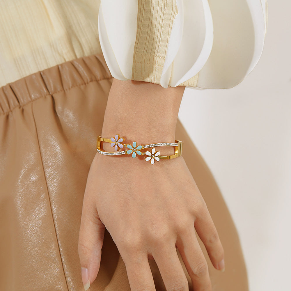 Little Daisy Gold Bracelet in hand of a white dressed woman