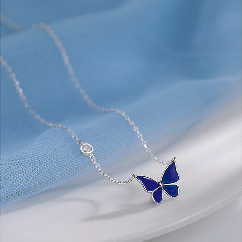 Deep Blue Color-changed Enchanted Butterfly Necklace over the bed