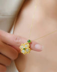 Girl holding Gold Green Clover Necklace