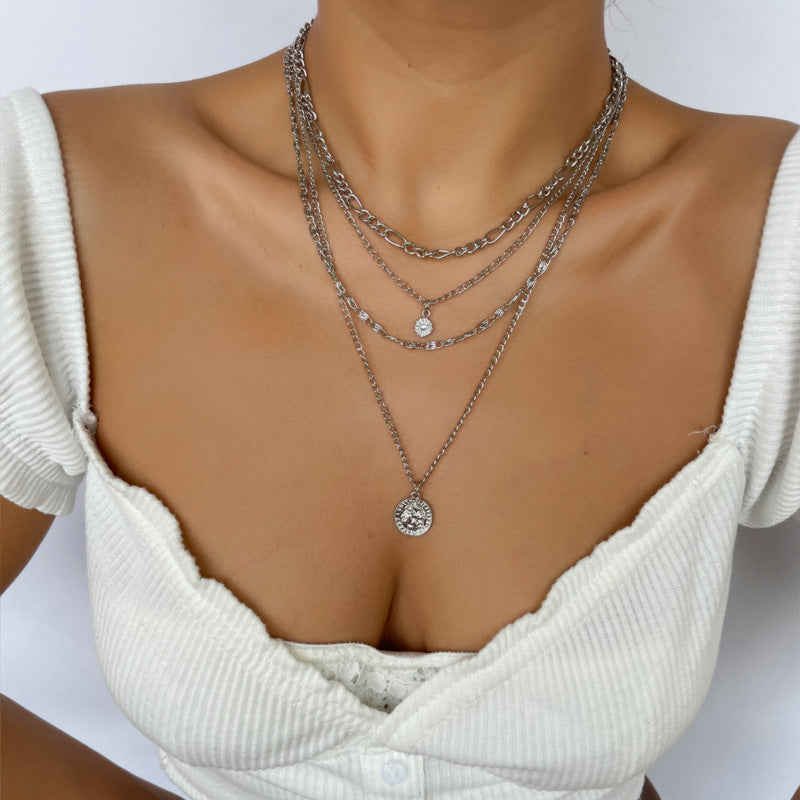 White dressed girl wearing Chunky Gold Charm Necklace