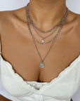 White dressed girl wearing Chunky Gold Charm Necklace