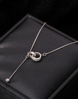 Luxury Two Interlocking Circles Necklace over a cushion 