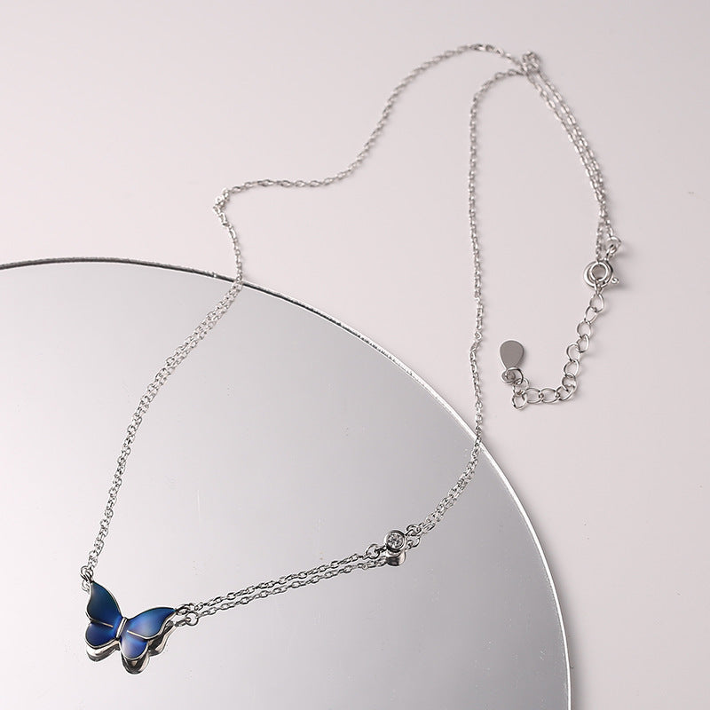 Blue Color-changed Enchanted Butterfly Necklace over a mirror