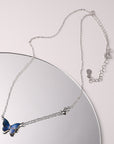 Blue Color-changed Enchanted Butterfly Necklace over a mirror