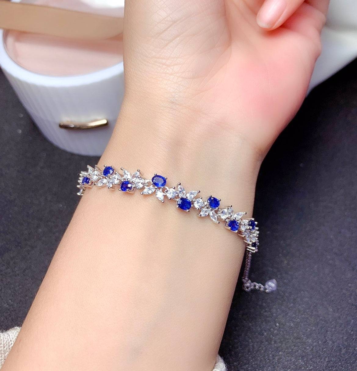 925 Sterling Silver Sapphire Bracelet in woman's hand