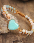 Amazonite String Braided Heart Bracelet held beside stone